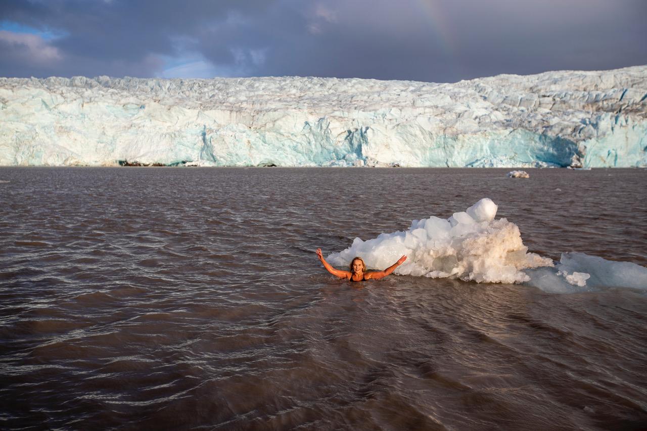 Anne Kristin Møller swimming in front of the Nordenskiöld glacier, Svalbard