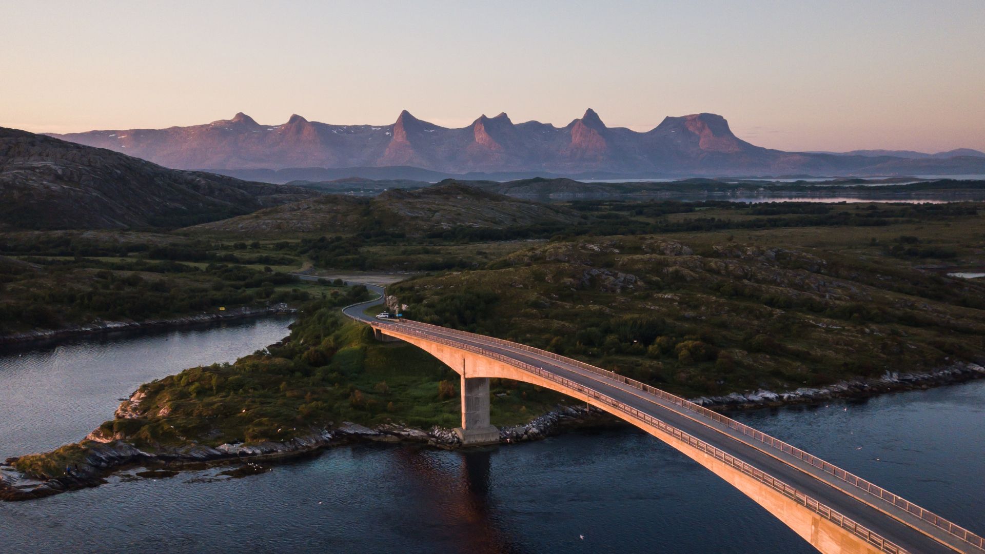 A bridge connecting Herøy to another island in Helgeland, Northern Norway. In the background, the mountain range The seven sisters.