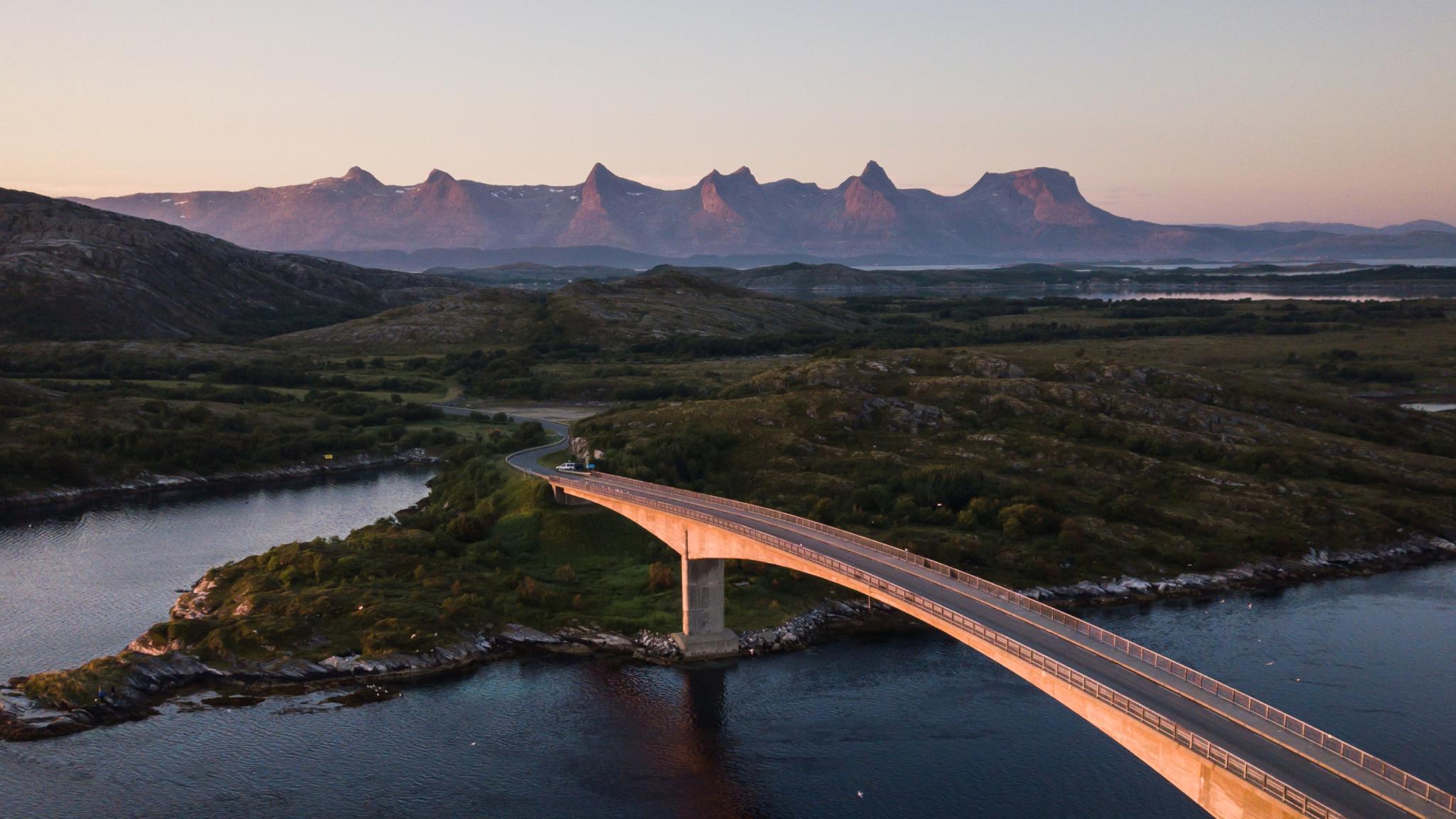 A bridge connecting Herøy to another island in Helgeland, Northern Norway. In the background, the mountain range The seven sisters.