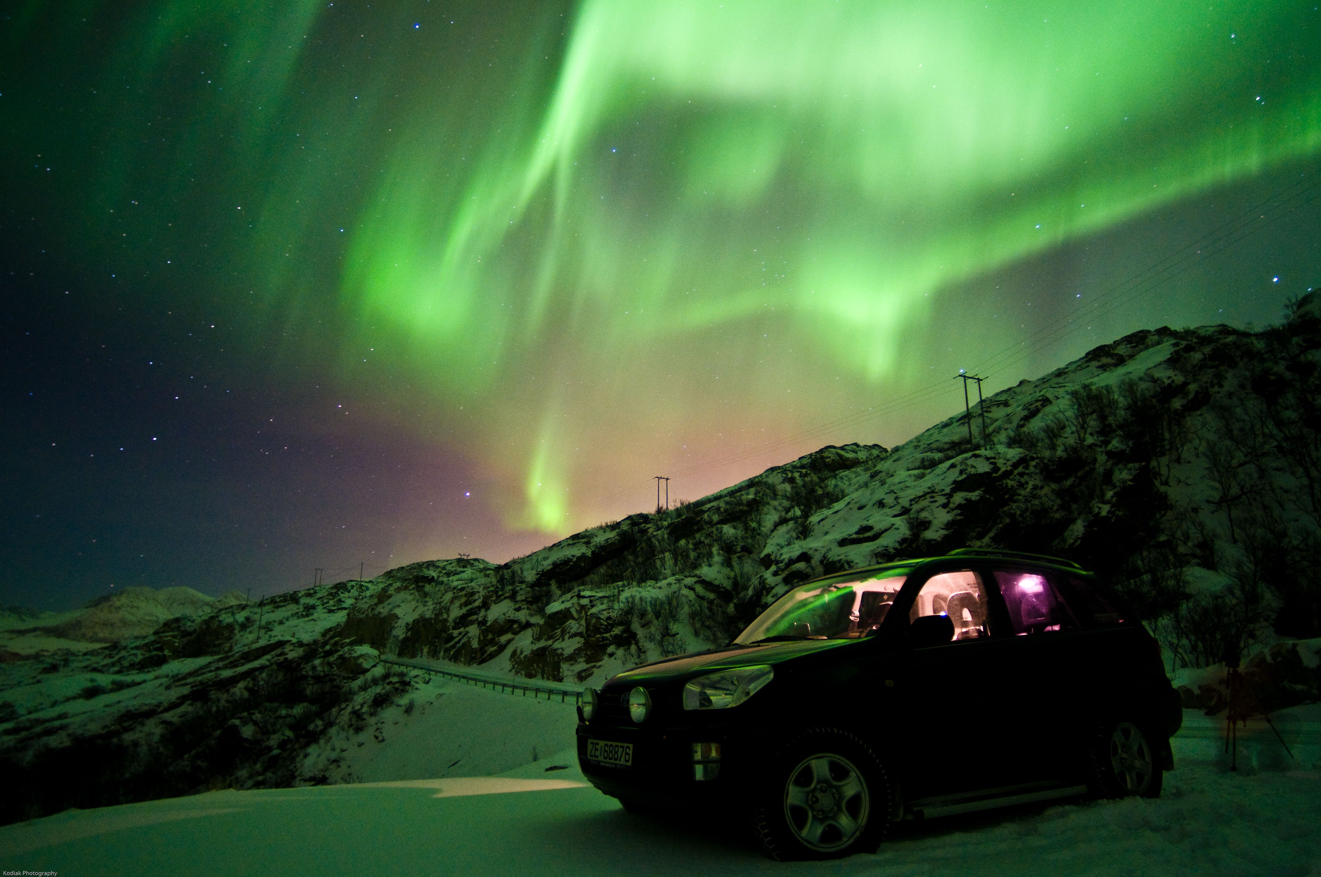 Car under the northern lights