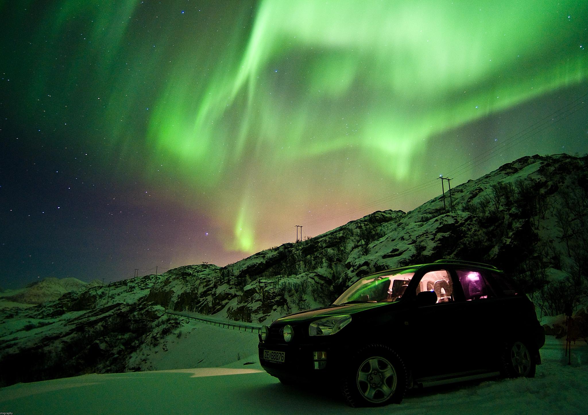 Car under the northern lights