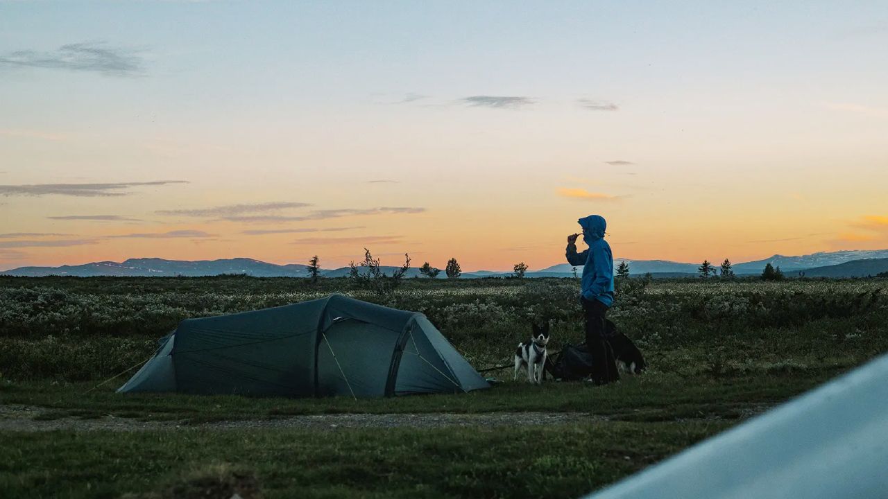 Man brushing teeth by the camp at the mountain