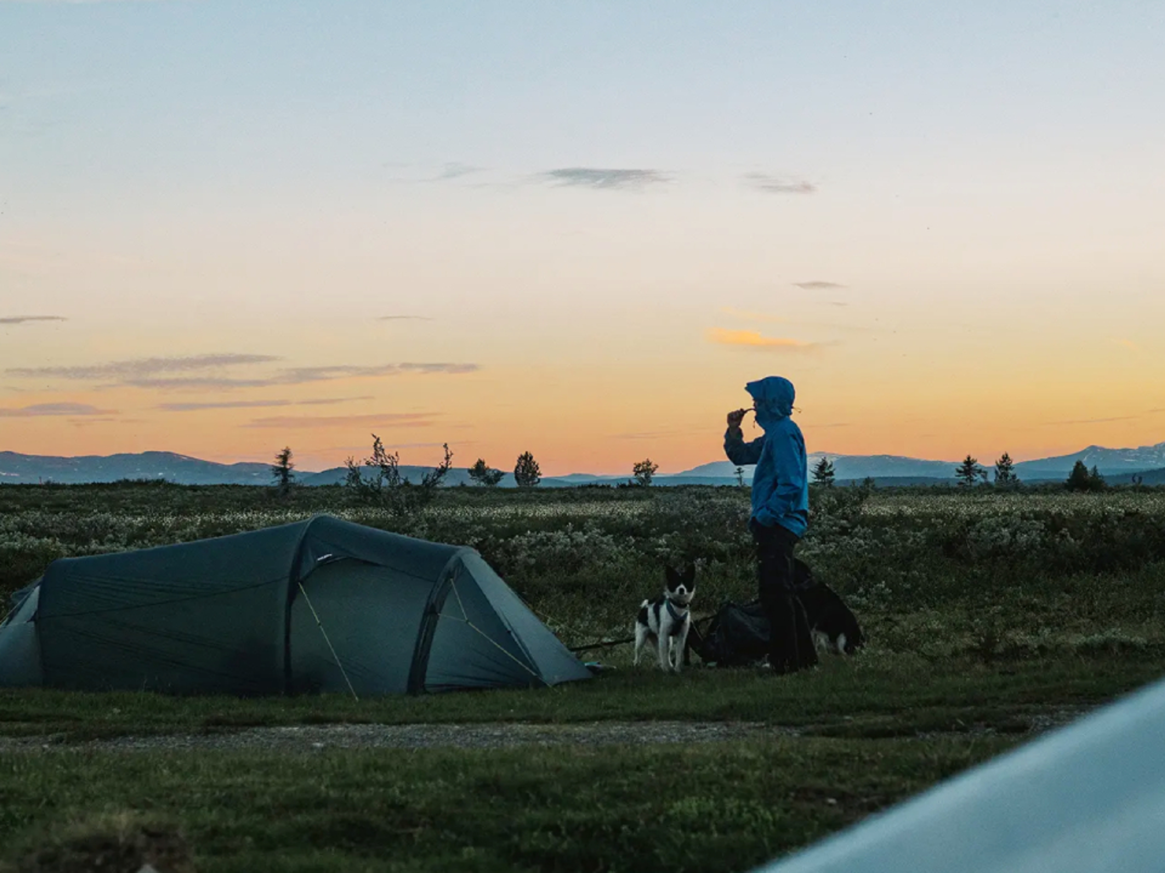 Man brushing teeth by the camp at the mountain