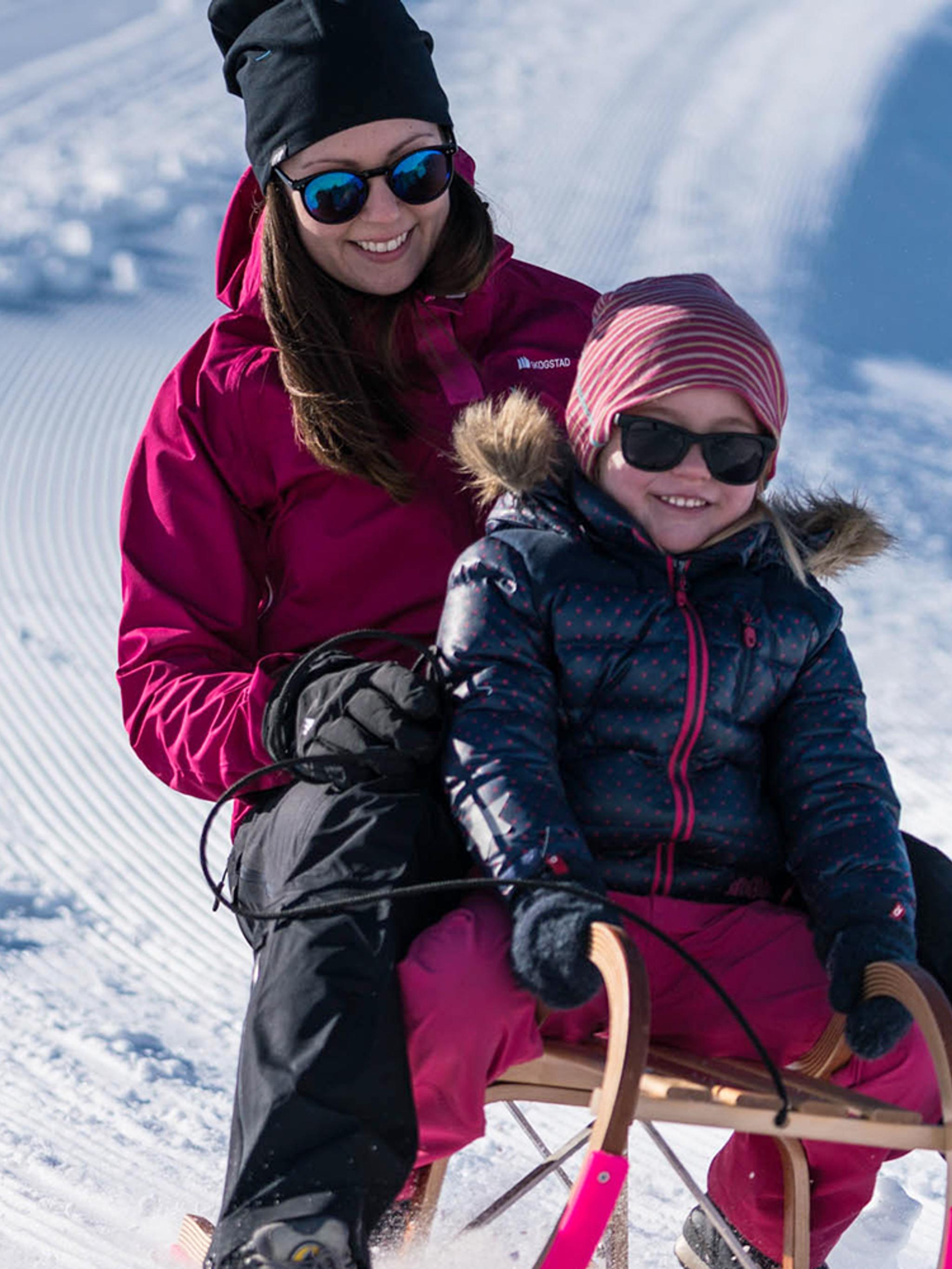 Mutter und Tochter beim Schlittenfahren am Berg Hofen beim Loen Skylift in Norwegen