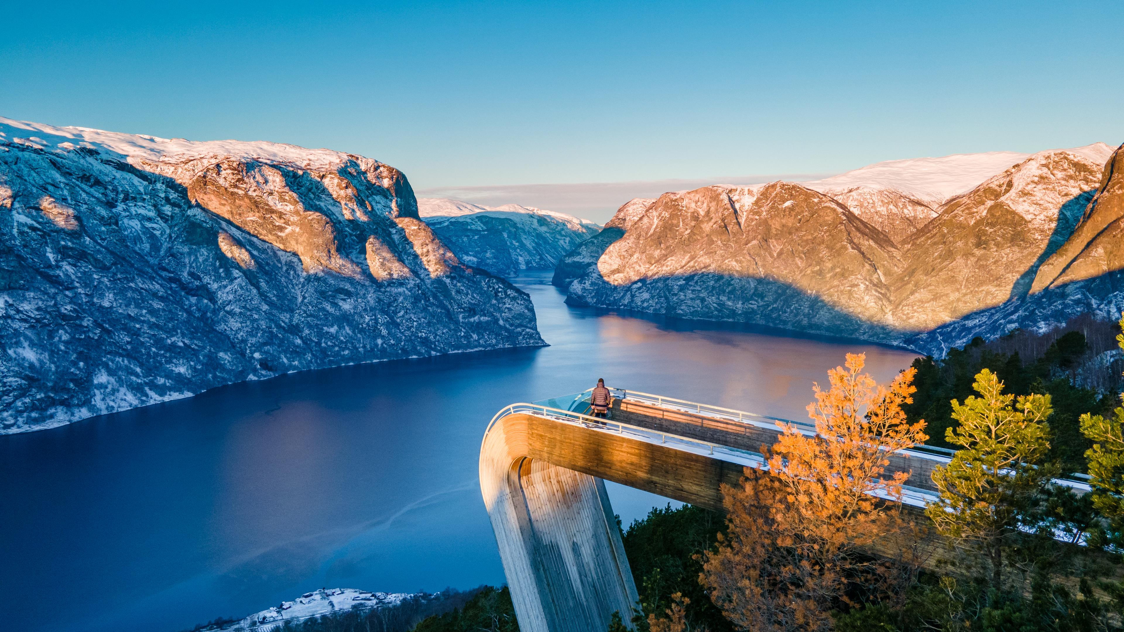A person on the Stegastein viewpoint overlooking Aurlandsfjorden