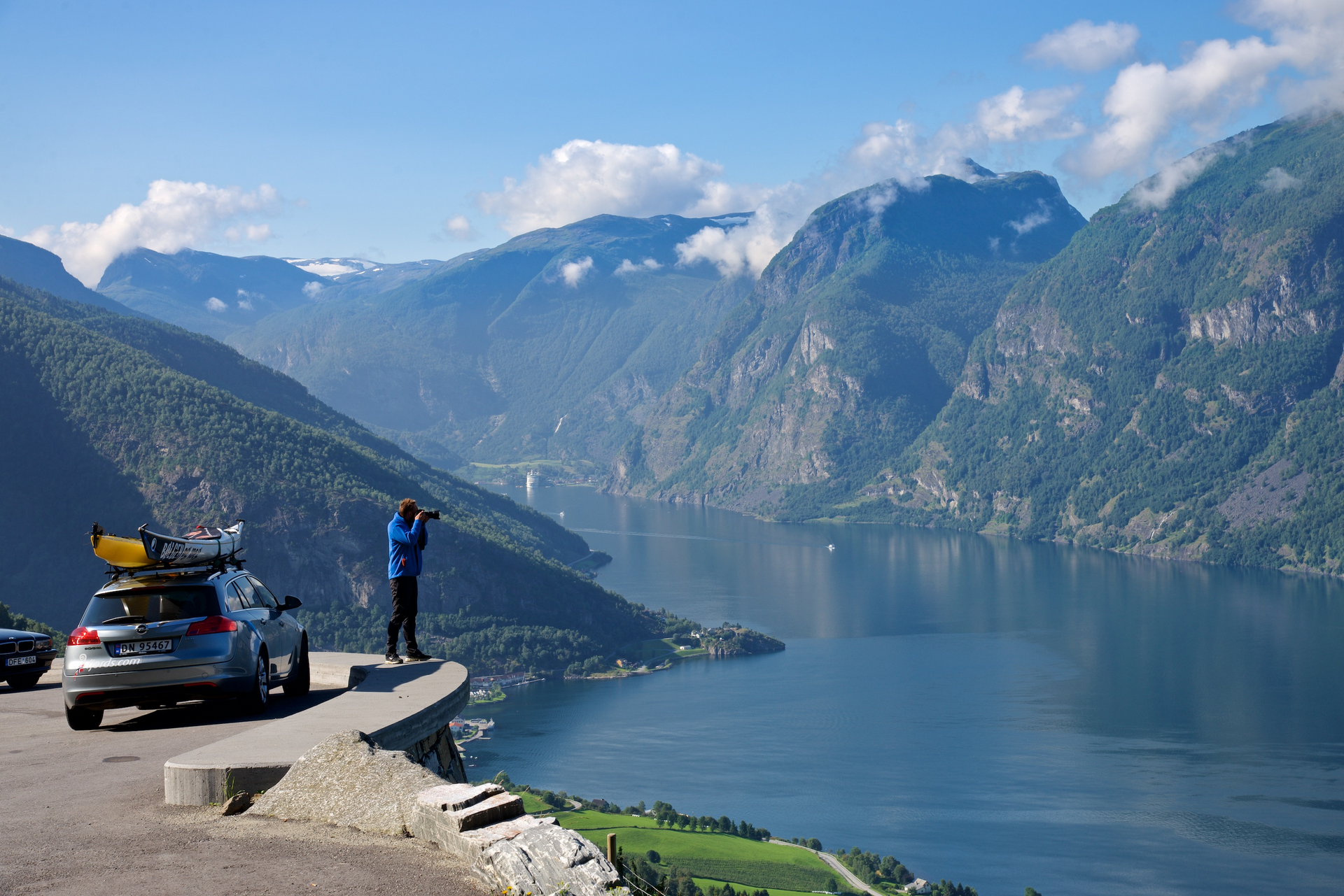 Car on the road among snowcapped mountains