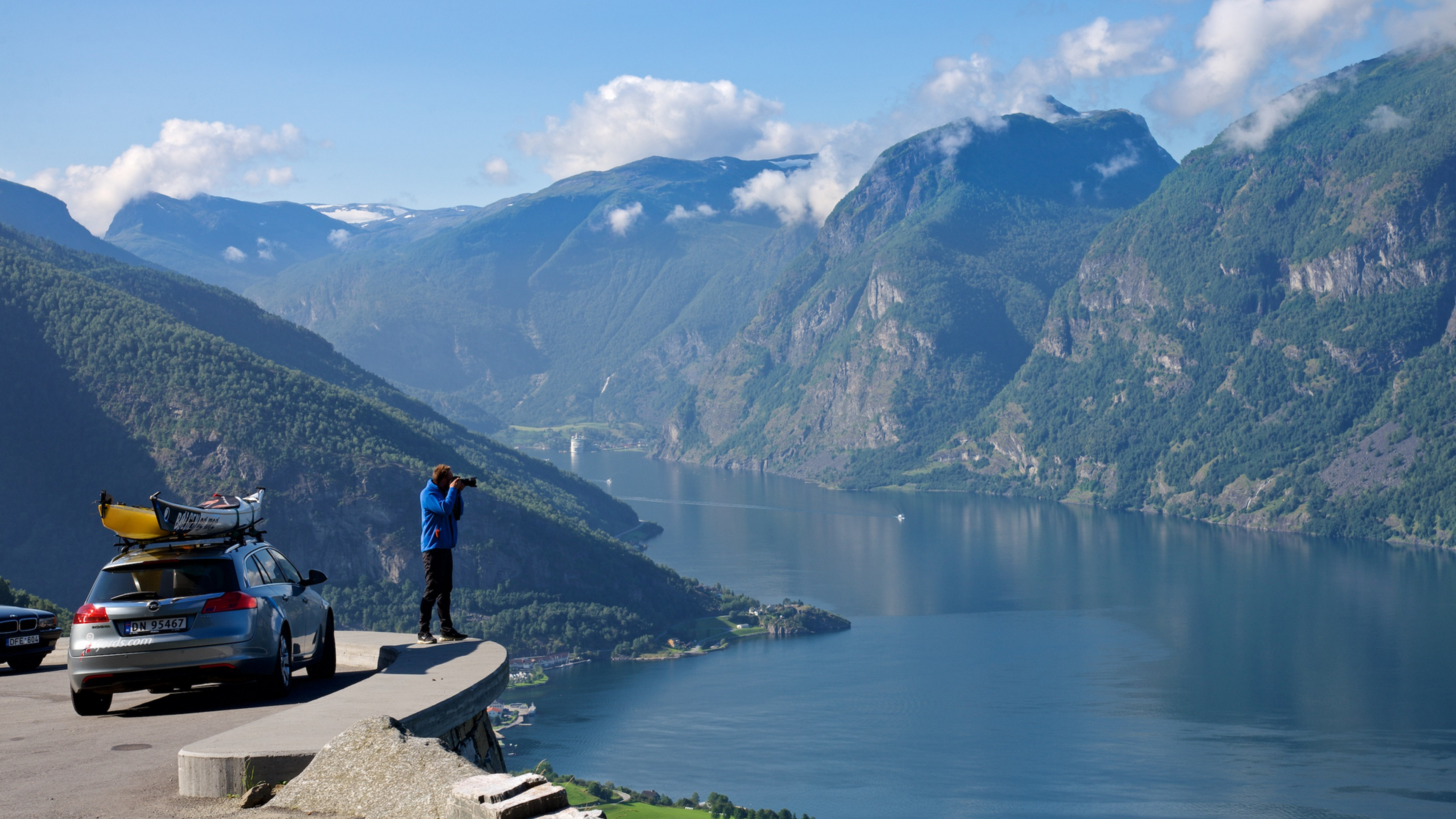Car on the road among snowcapped mountains
