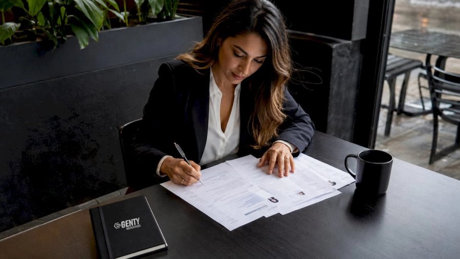 Hiring manager reviewing printed resumes