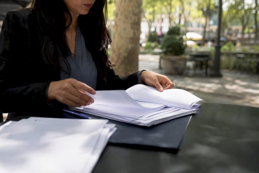 Hands handling labor contribution documents