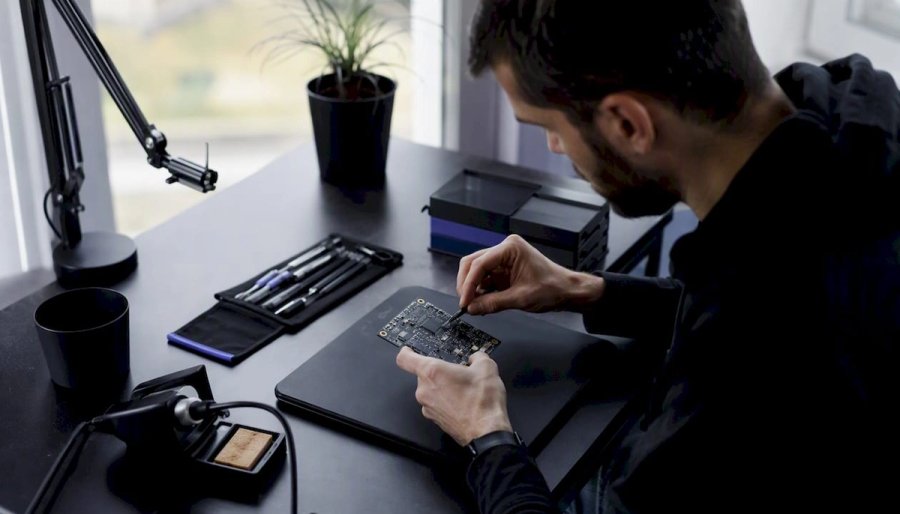 Hands inspecting electronic hardware component