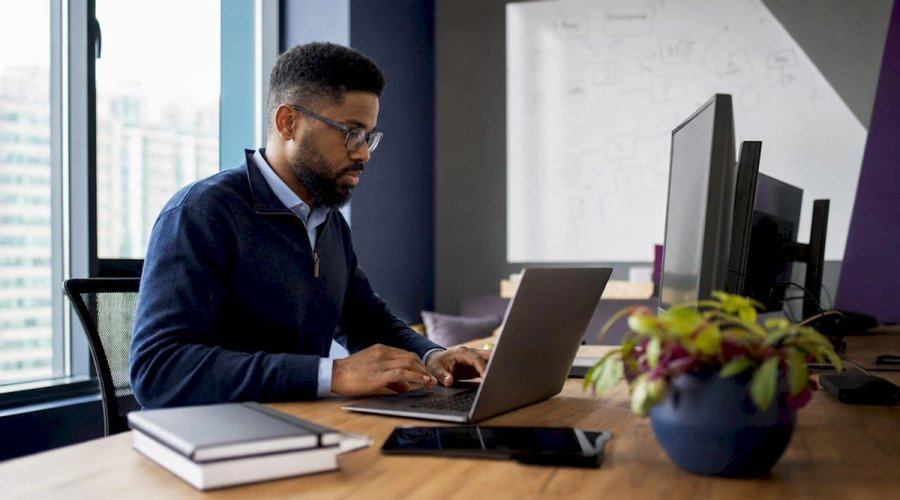 DevOps engineer working at standing desk