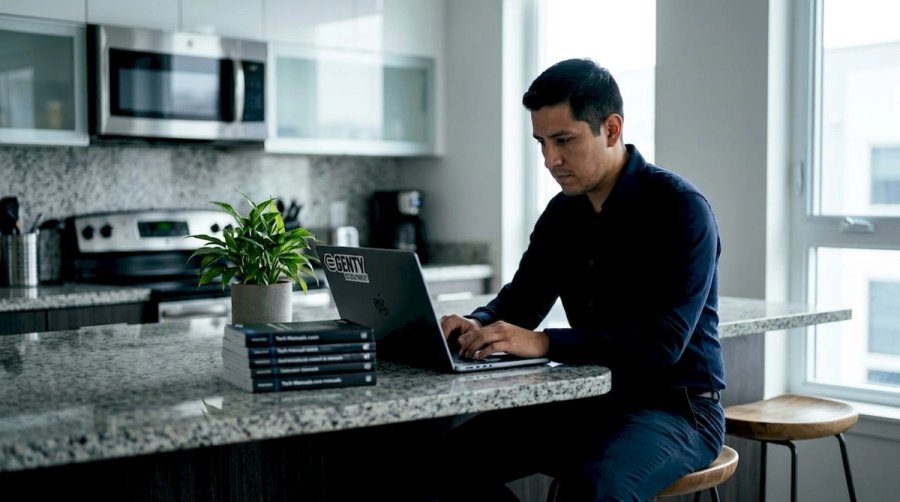 Remote tech engineer typing English email in home office