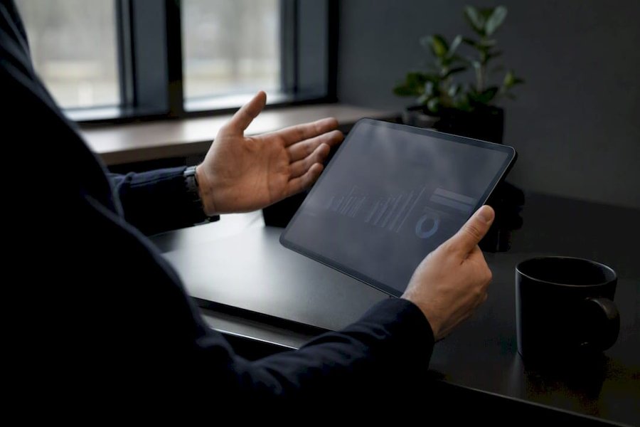 Hand pointing at budgeting notes open on notebook