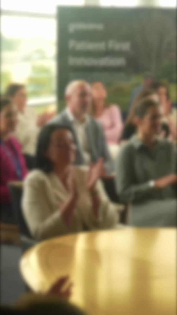Team members applauding at a Patient First Innovation presentation, teasing the 25.08.2026 rebrand