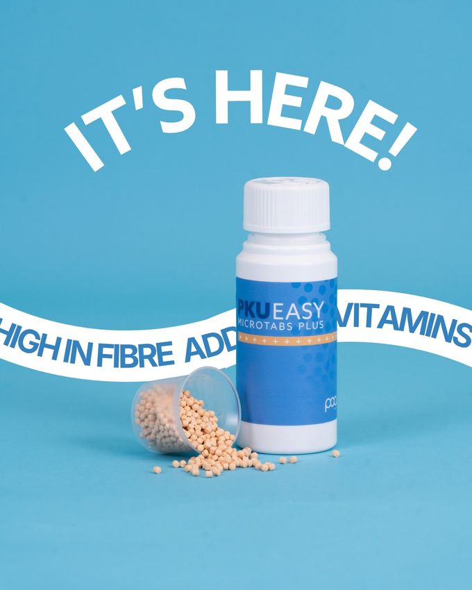 PKU Easy Microtabs Plus bottle on a blue background with microtabs spilling from a cup, under the words It's Here