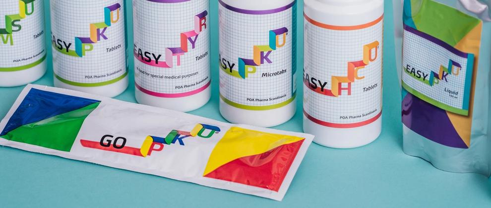 Range of EasyPKU tablets, microtabs, and liquid products alongside a GoPKU sachet by POA Pharma Scandinavia