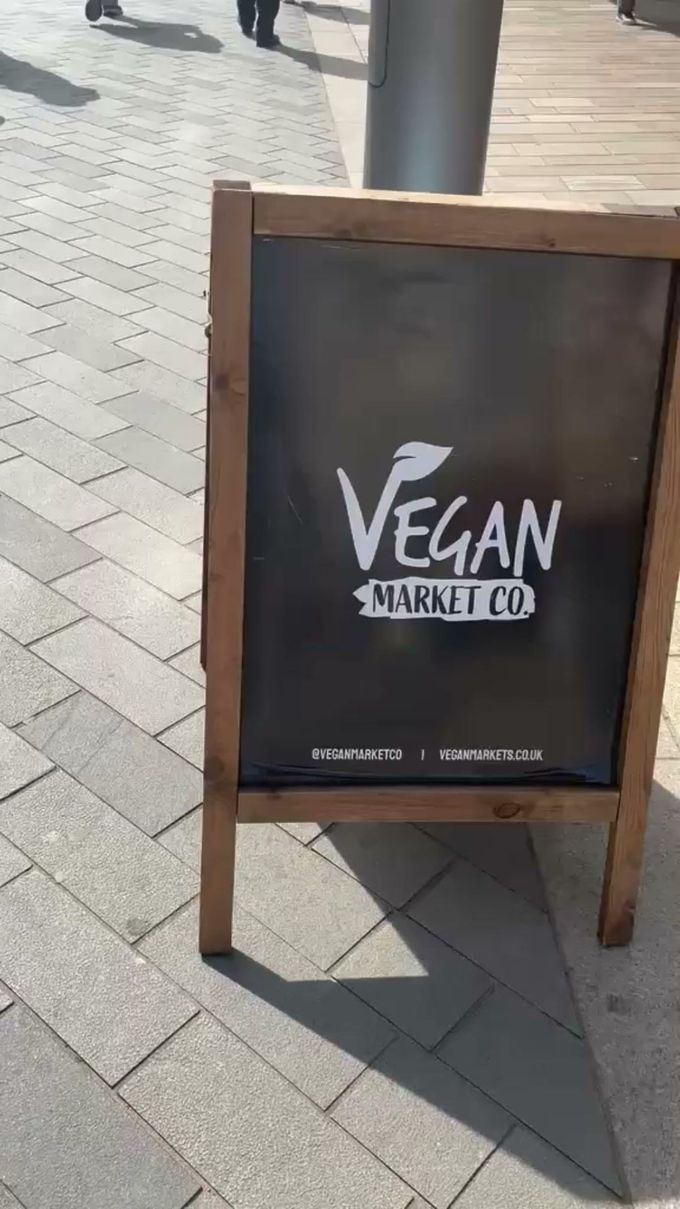 Vegan Market Co chalkboard sign on a paved street at the Vegan Festival