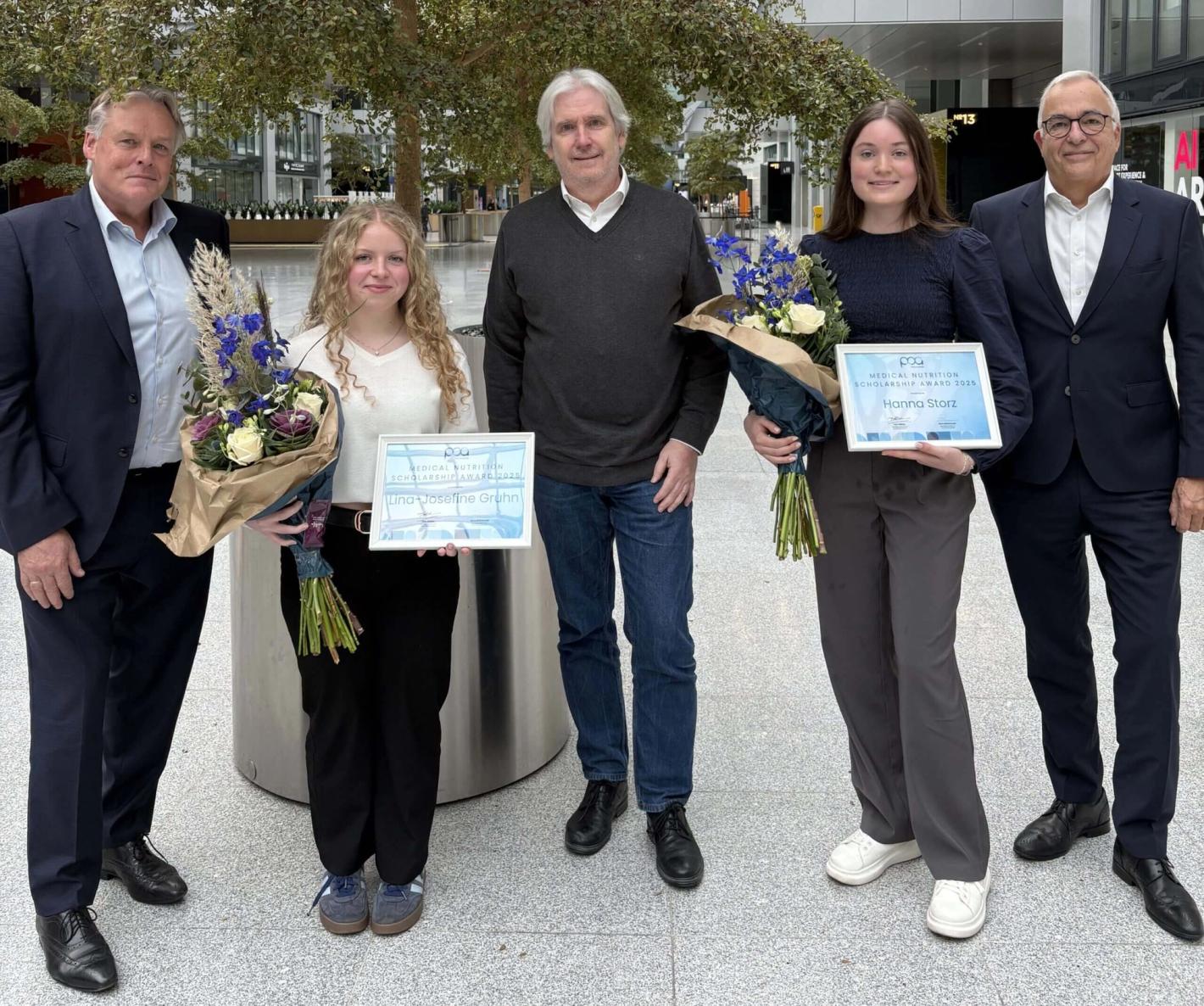 Lina Josefine Gruhn og Hanna Storz med deres Medical Nutrition Scholarship Award 2025-certifikater og blomsterbuketter