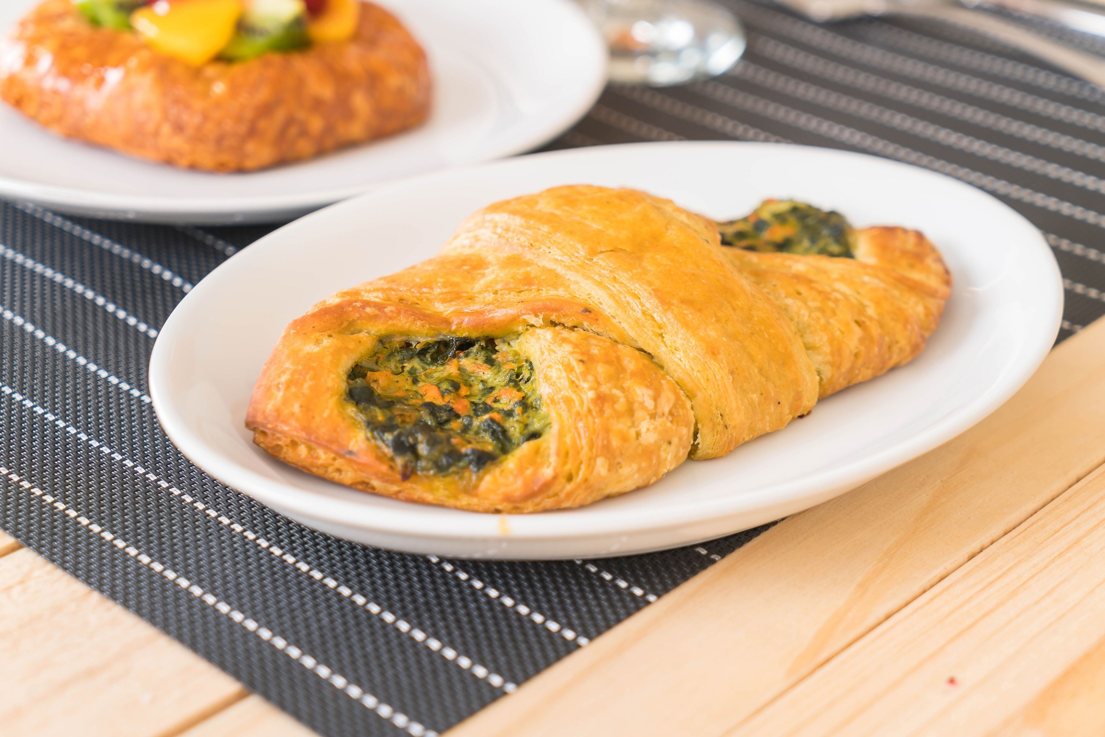Savory spinach pastry on a white plate.