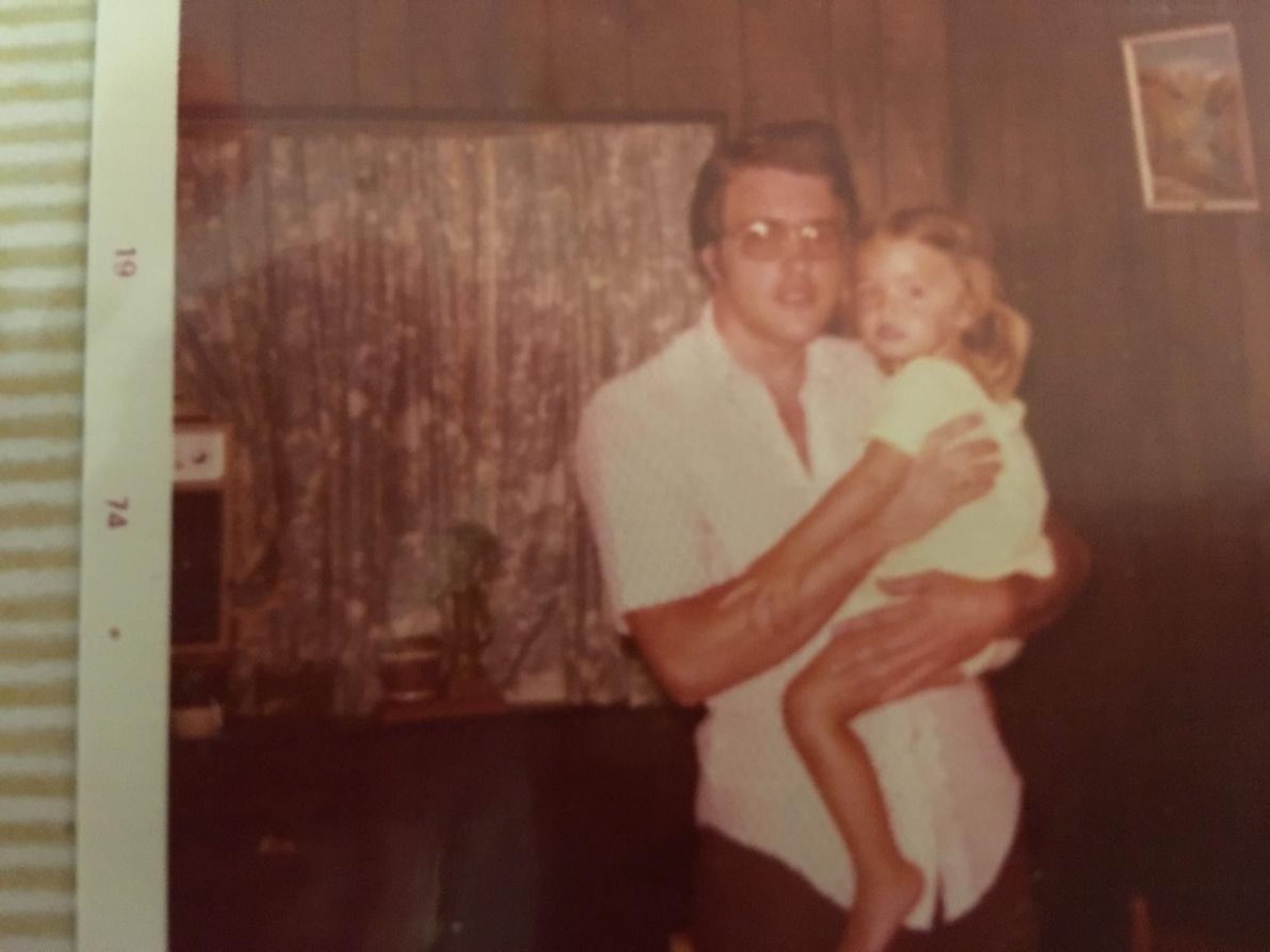 man holding his niece in 1975.