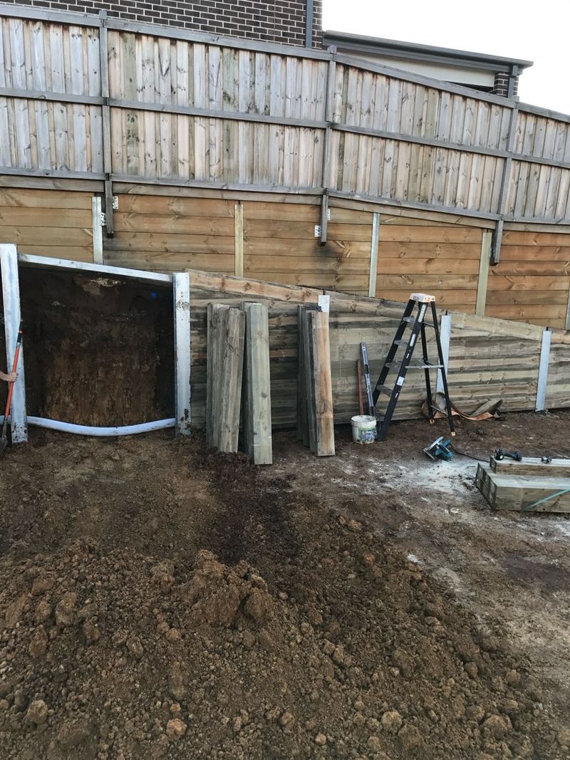 Timber sleepers being installed between steel posts during the staged build