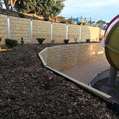Block-finish retaining walls with concrete capping through the water park at Adventure Park Geelong, Wallington