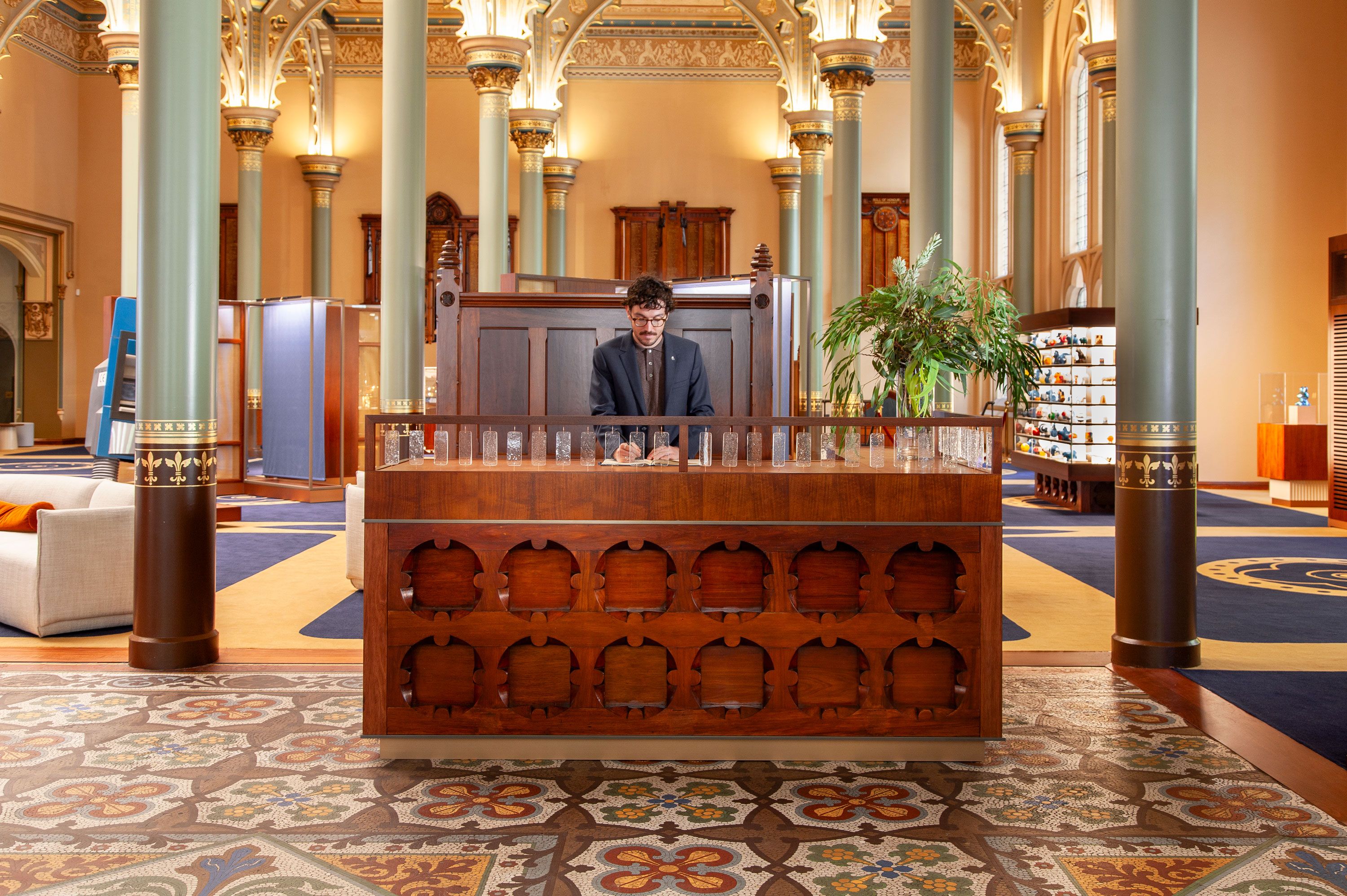 The concierge desk at the ANZ Museum by Foolscap. Housed in Melbourne's Gothic Bank, the interior has been sensitively refurbished and transformed to allow more public access. Materials from the existing fitout have been weaved into the new design, such as timber bank teller counters being turned into joinery throughout the space.