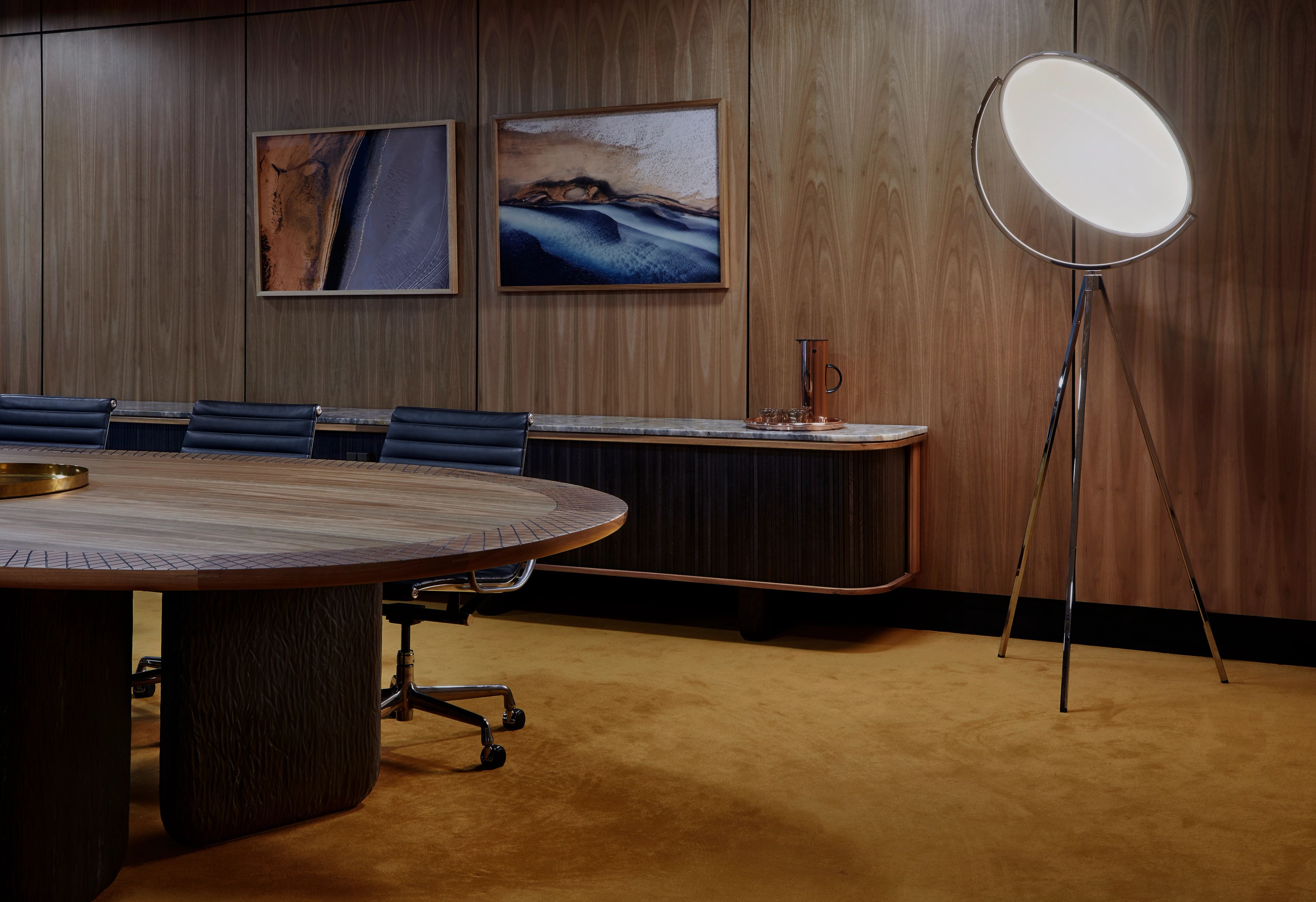 The boardroom of Melbourne Airport Headquarters by Foolscap. The premium workspace includes timber-panelled walls and a custom table and sideboard from First Nations makers Manapan. 