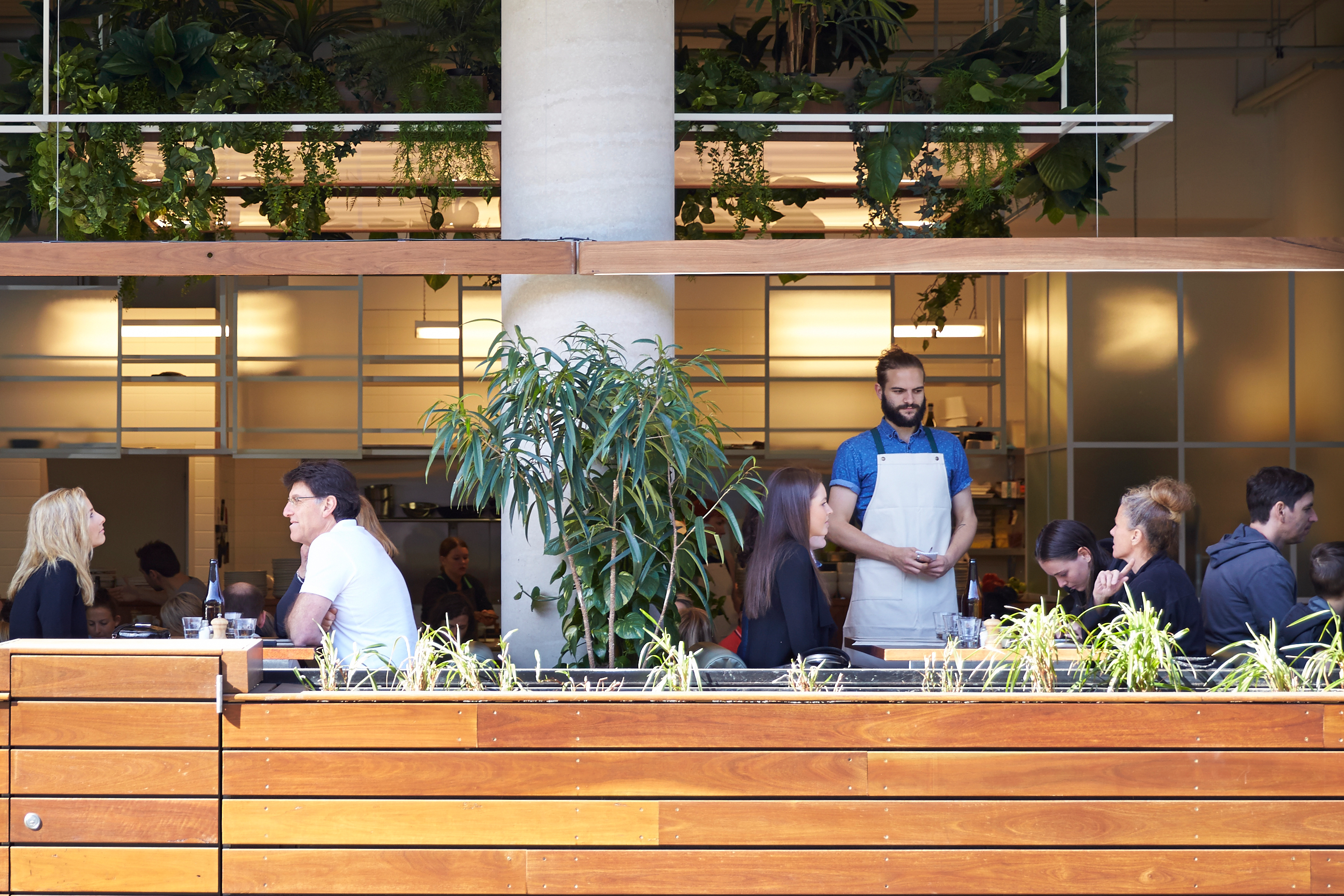 People enjoying food in the alfresco area of Bawa, a specialty coffee cafe and restaurant designed by Foolscap in Hawthorn, Victoria.