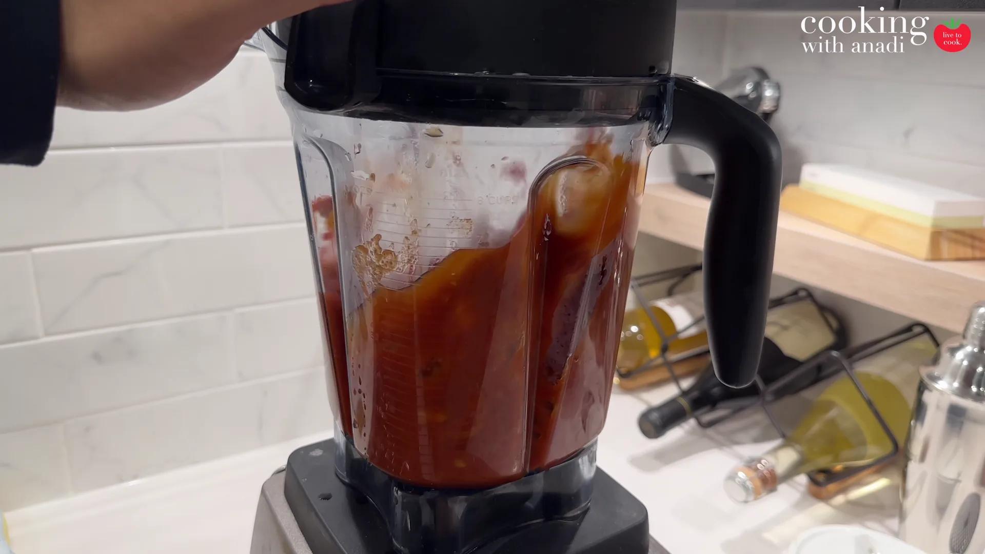 A red chili sauce blending in the Vitamix jug