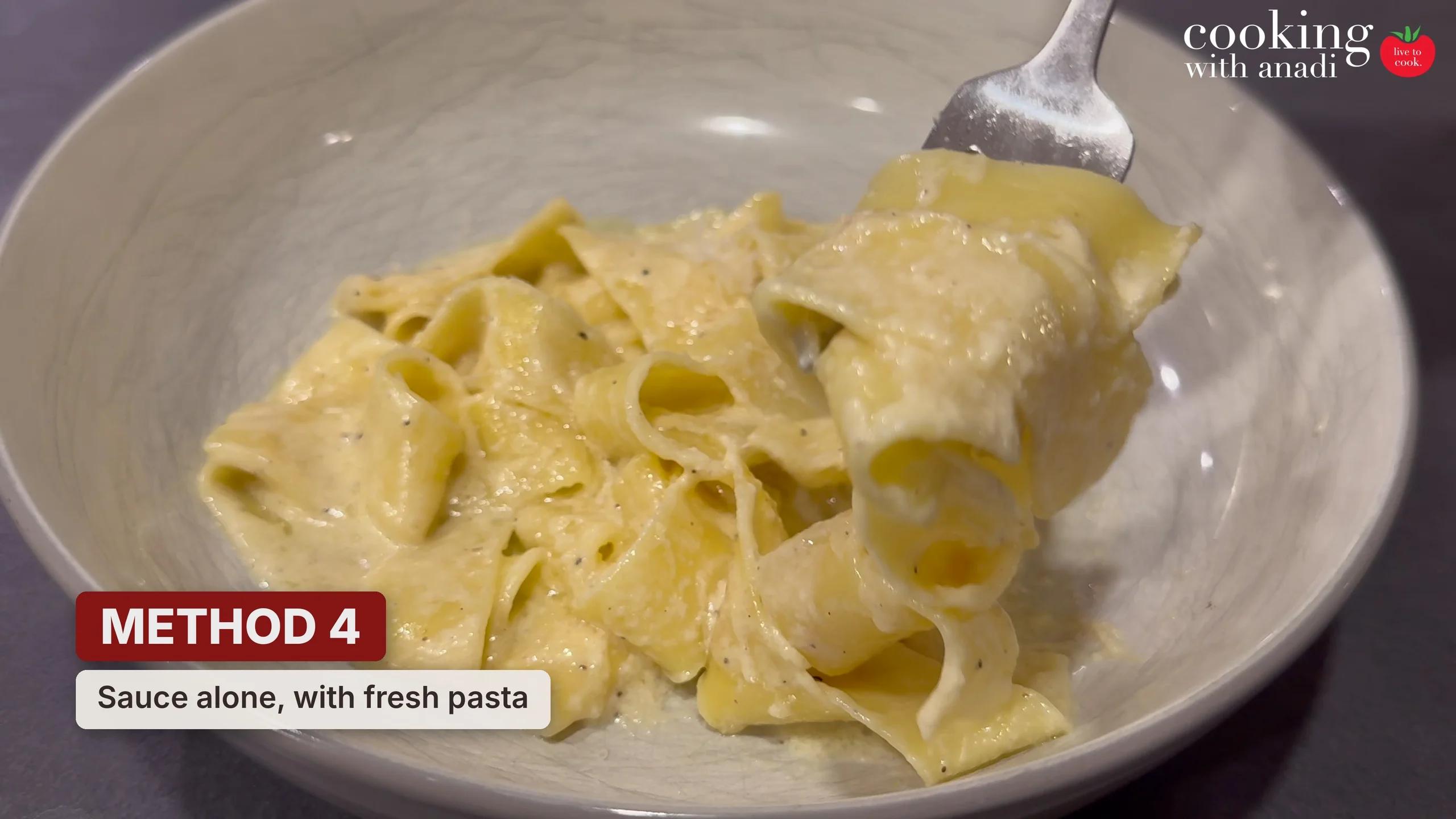 Alfredo sauce reheated on its own and tossed with freshly cooked pasta, thick sauce coating every ribbon
