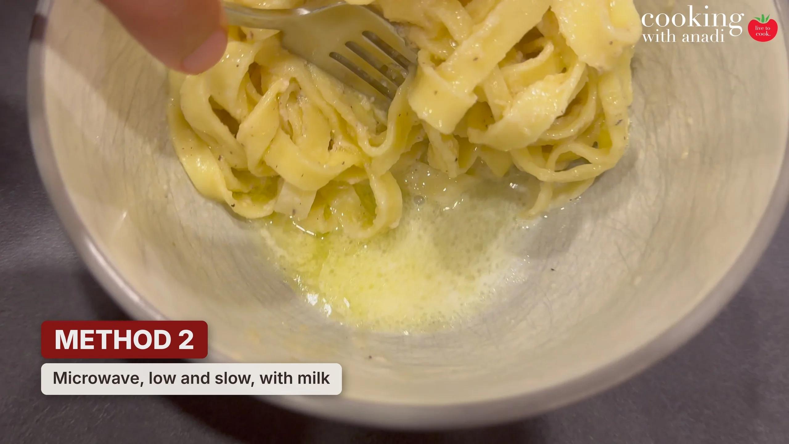 Leftover fettuccine alfredo microwaved in short bursts with milk, with a smaller pool of liquid in the bowl