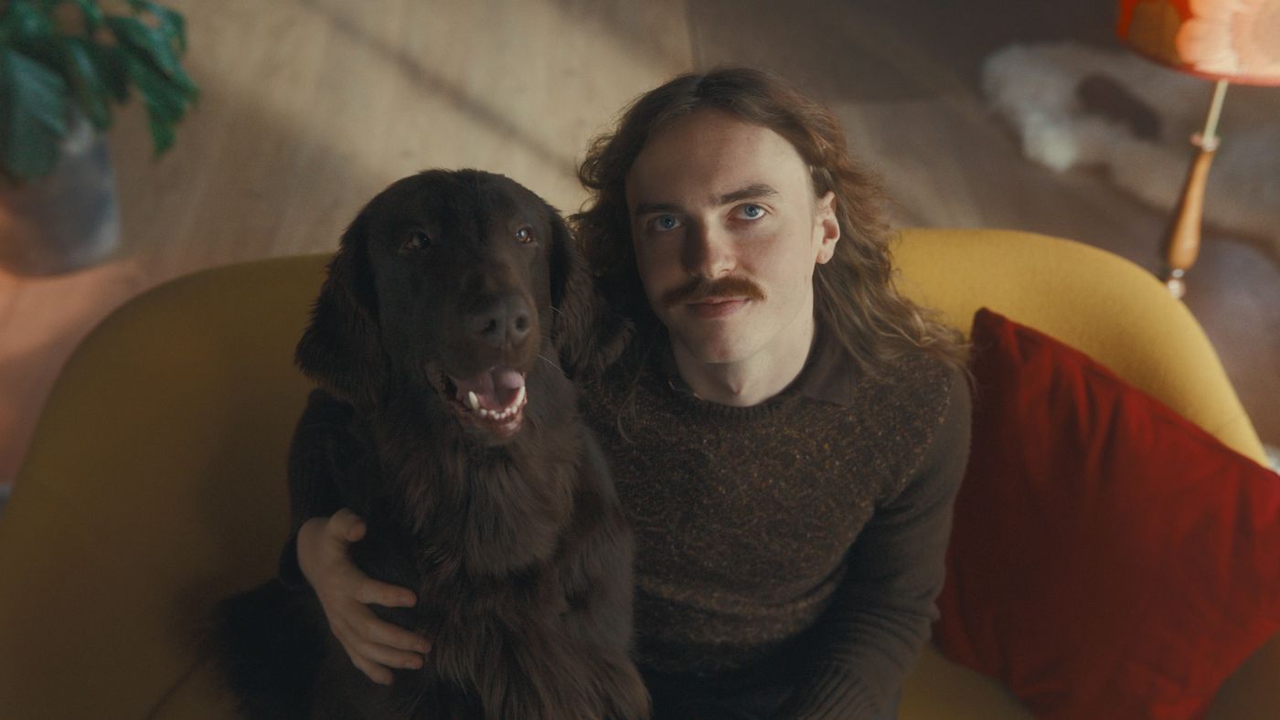 Hund og mann ser på varmepumpen