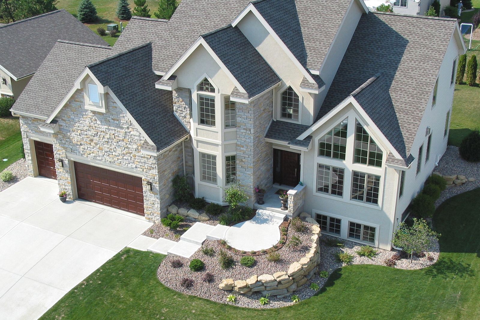 An aerial view of a completed roof replacement on a two-storey suburban home