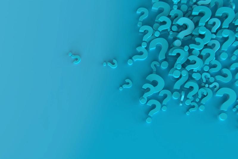 A cluster of three-dimensional, blue question marks in varying sizes appears on the right side of the image, set against a smooth, gradient blue background. A few question marks are isolated and scattered towards the left side, symbolizing the complexities and uncertainties often addressed by effective marketing campaigns.