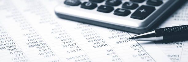 Calculator and pen on financial documents.