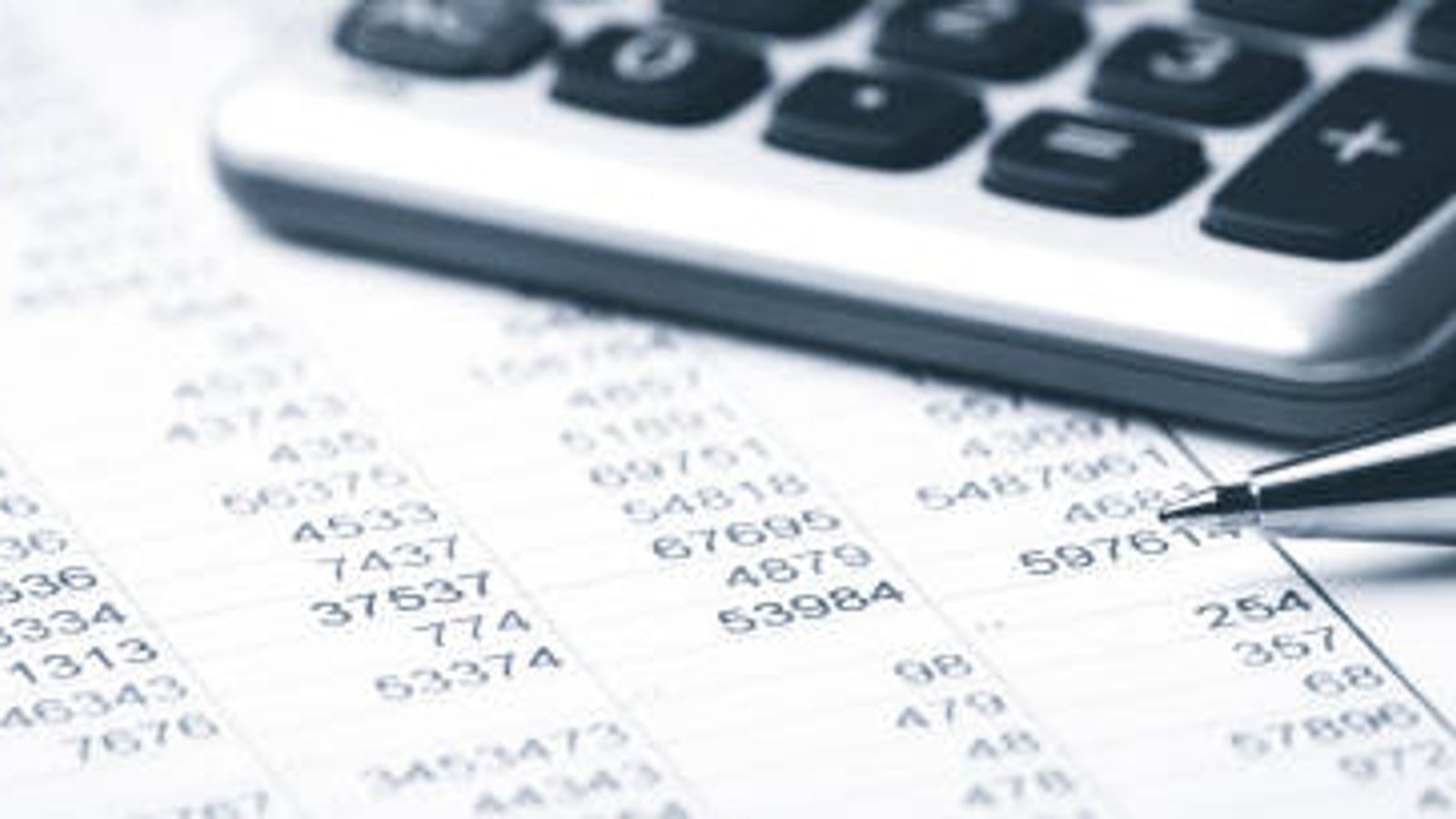 Calculator and pen on financial documents.