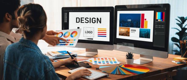 Designers collaborating on computer graphics and logos.