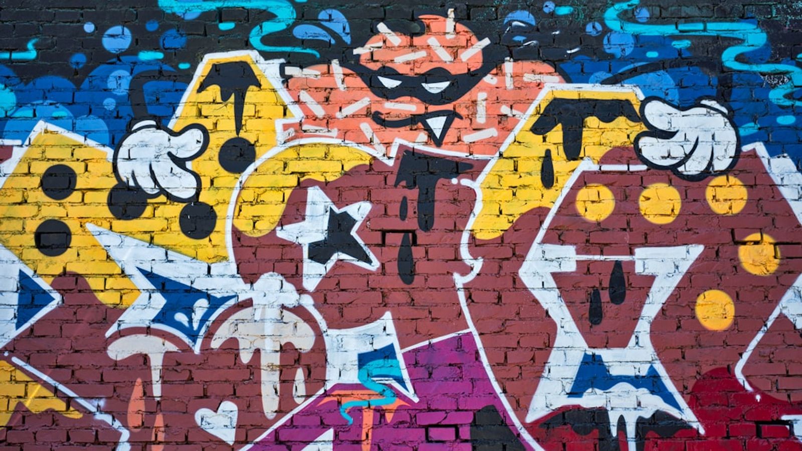 Vibrant street-art graffiti on a brick wall — the guerrilla-marketing aesthetic