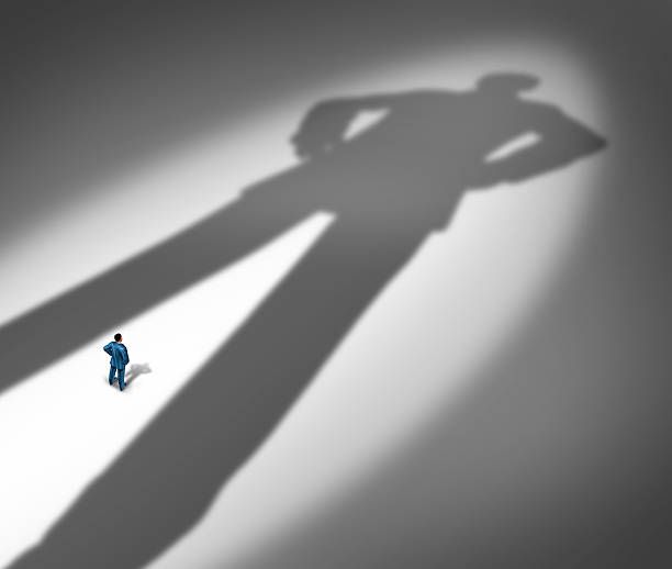 Man casting large shadow on ground