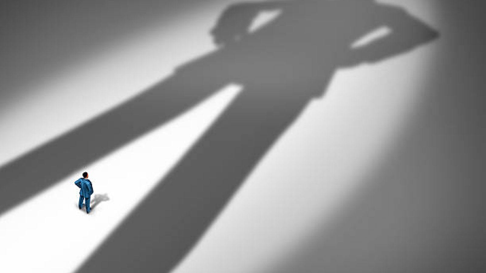 Man casting large shadow on ground