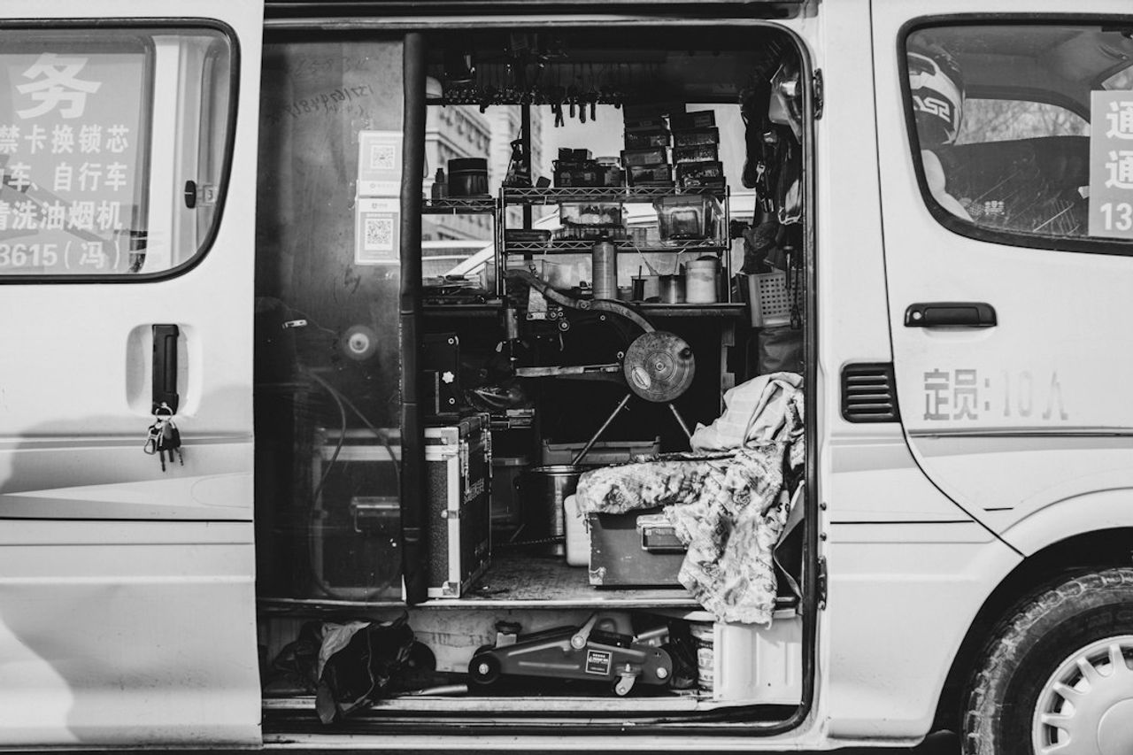 The inside of a work van fitted out with shelves and tools as a mobile workshop.