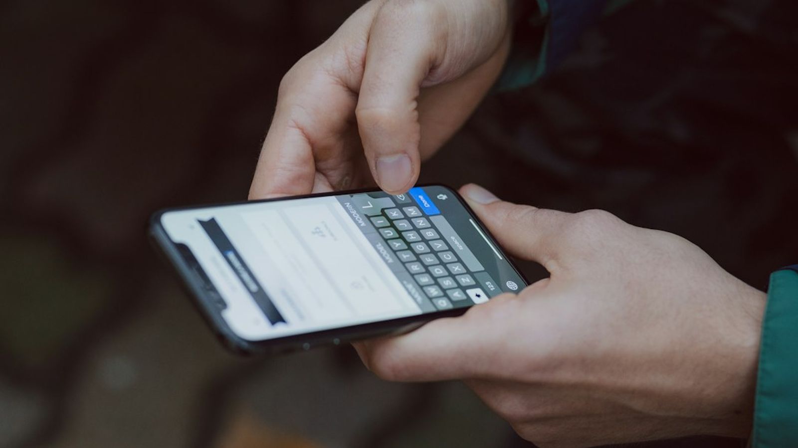A person typing on a smartphone.
