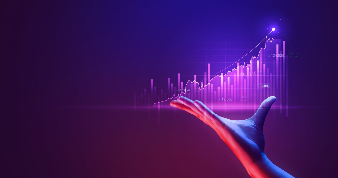 A hand is shown with the palm facing upwards, presenting a digital graph. The graph features a purple background and various upward-trending lines and data points, suggesting financial growth or positive economic trends. A bright light highlights the peak of the graph, showcasing the potential of Madison WI's marketing agency expertise.