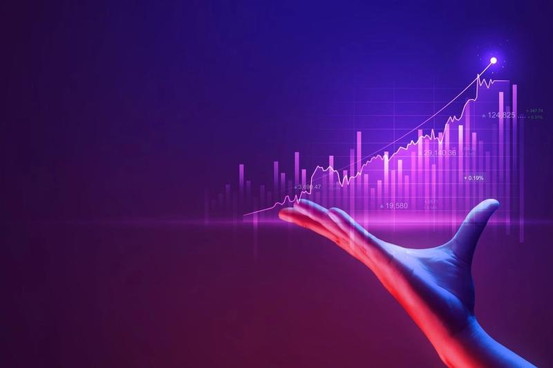A hand is shown with the palm facing upwards, presenting a digital graph. The graph features a purple background and various upward-trending lines and data points, suggesting financial growth or positive economic trends. A bright light highlights the peak of the graph, showcasing the potential of Madison WI's marketing agency expertise.