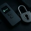 A digital lock device next to a metallic padlock