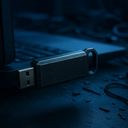 A USB drive plugged into a laptop with cables