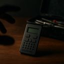 A dark setting featuring a small device with