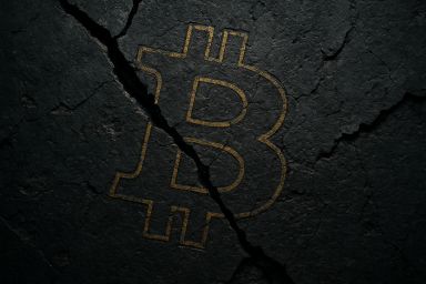Cracked dark surface with a Bitcoin symbol