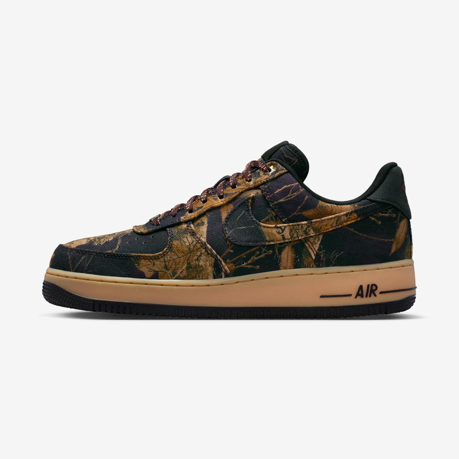 Nike Air Force 1 shoe with a dark forest camouflage upper, black accents, and a tan sole.